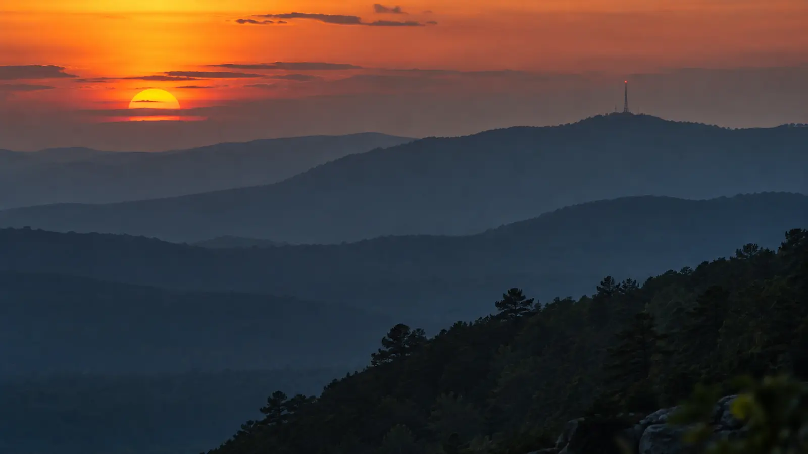 Ridgelines at dusk with a communications tower on the far peak